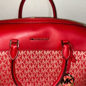 Large Red MK Purse with gold logo and longer strap in satchel shape.